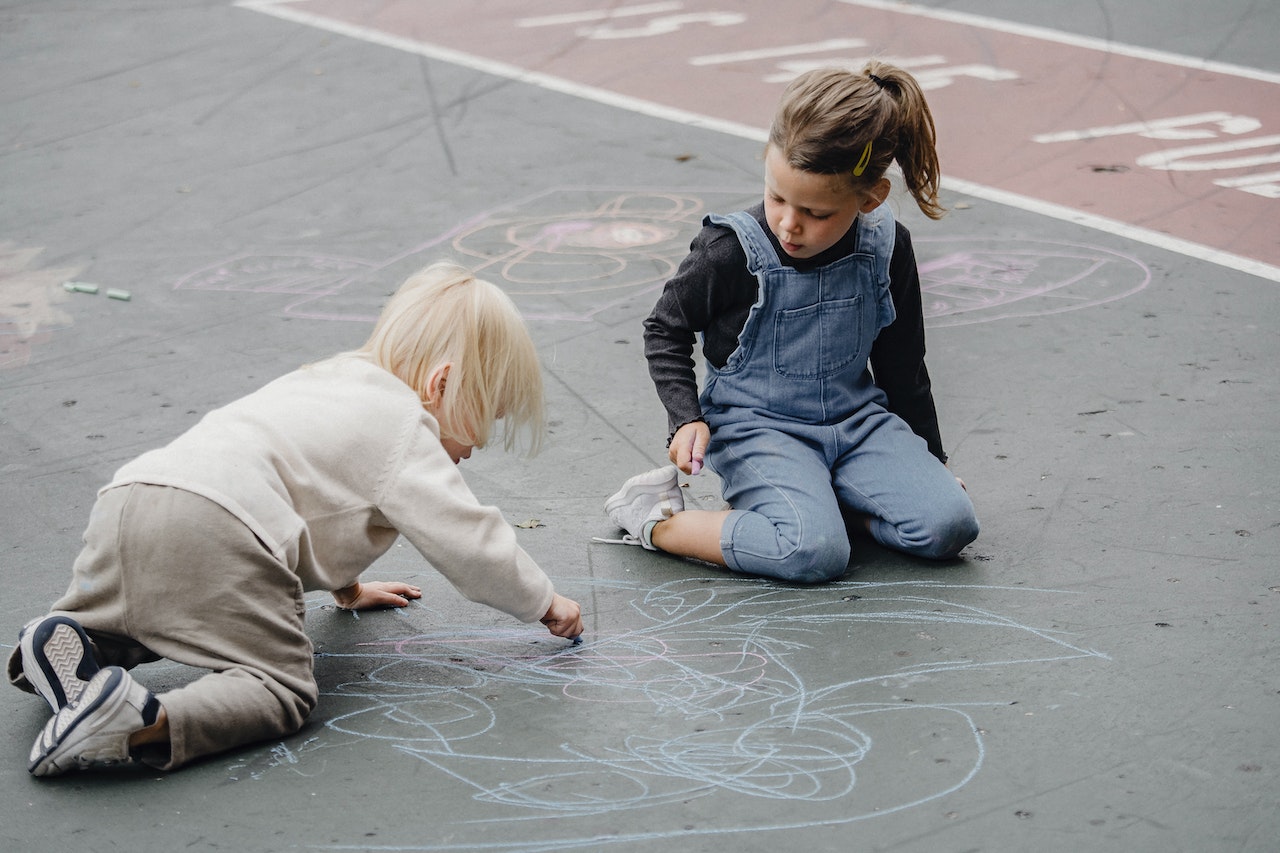 Adorable girls drawing on asphalt | Kids Car Donations