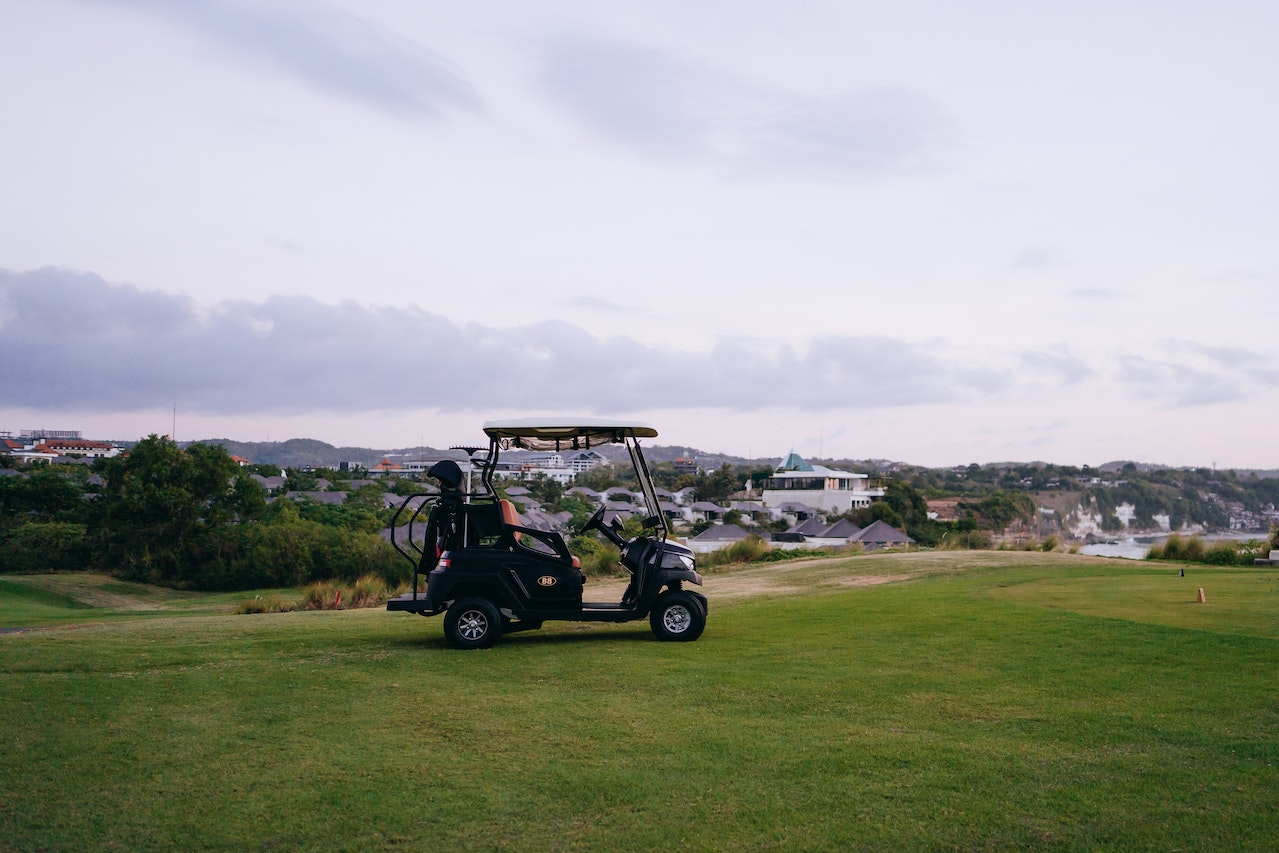 Golf Cart on Green Grass Field Under White Clouds | Kids Car Donations