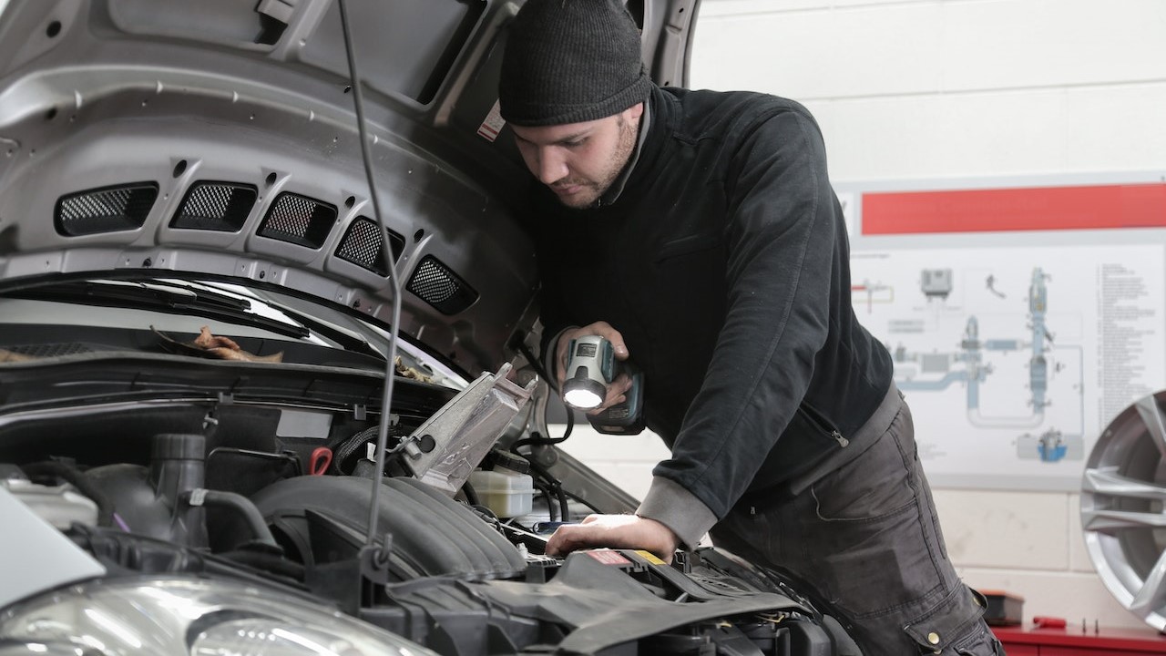 Man checking the engine of a car | Kids Car Donations