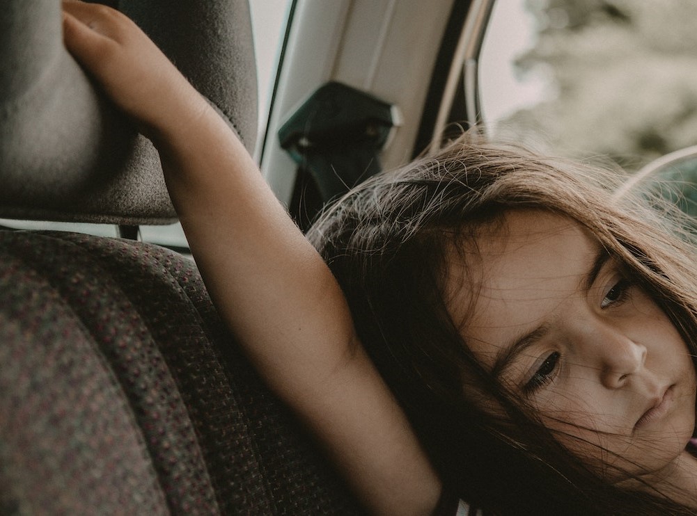 A Young Girl Sitting Inside the Car | Kids Car Donations