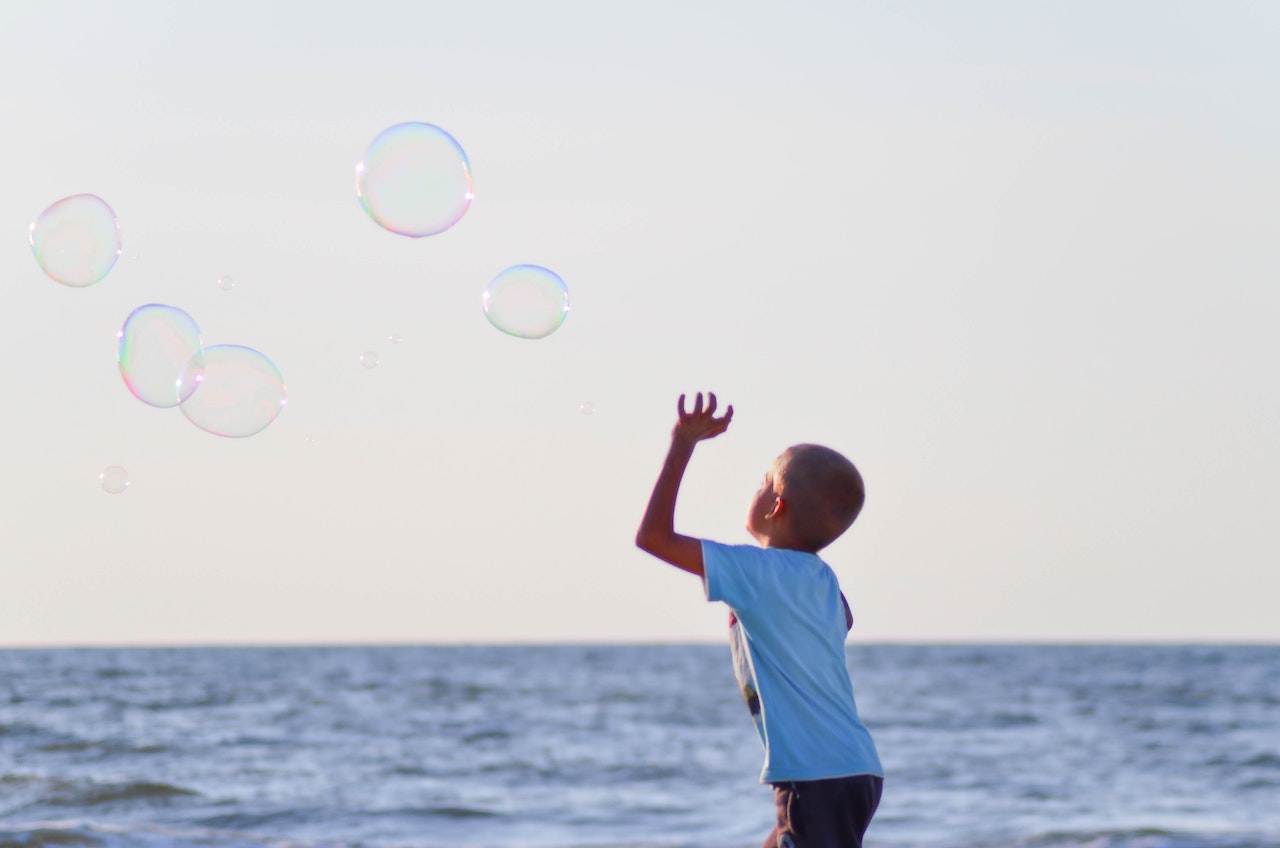 Boy in White T Shirt Playing Bubbles | Kids Car Donations