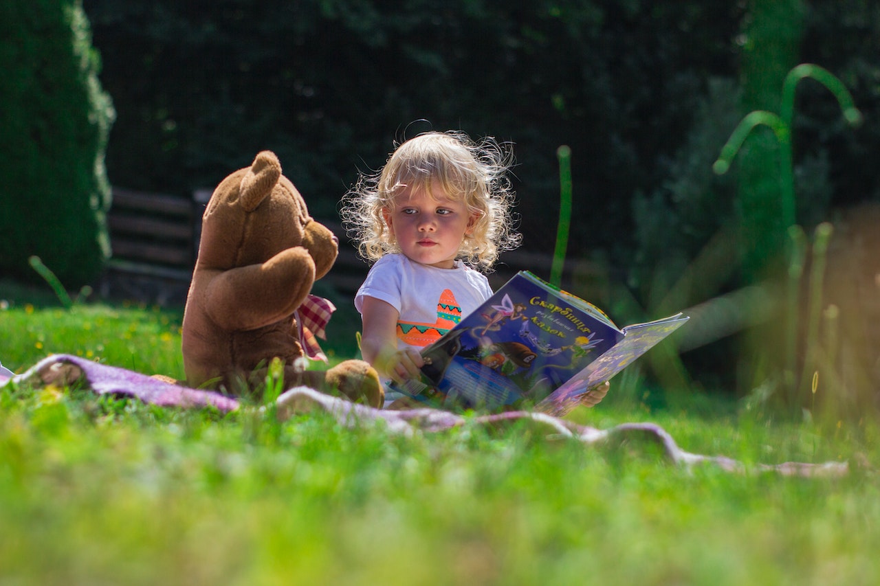 Girl Sitting Beside A Teddy Bear | Kids Car Donations
