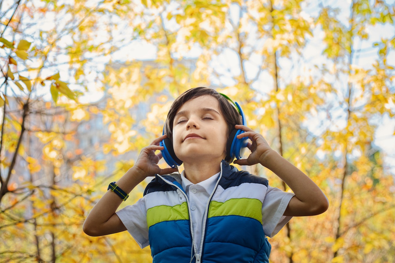 Photo of a Boy Listening in Headphones | Kids Car Donations