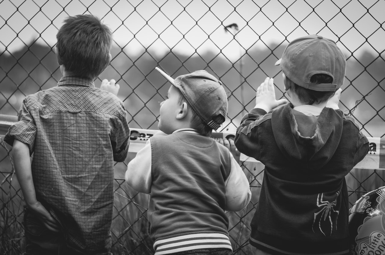 Three Boys Facing Towards Fence | Kids Car Donations