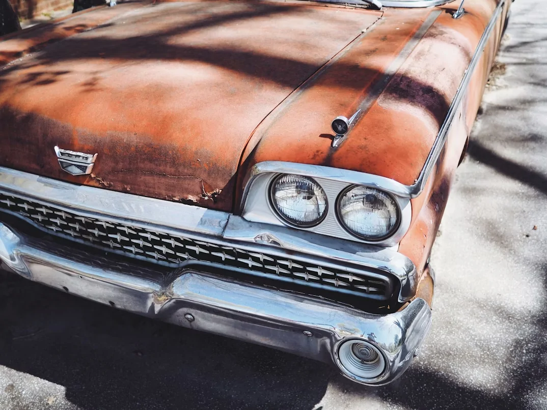 Vintage orange Cadillac parked outdoors