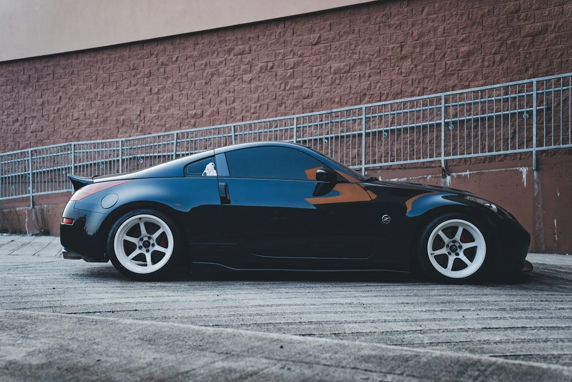 Black sports car parked in front of a building