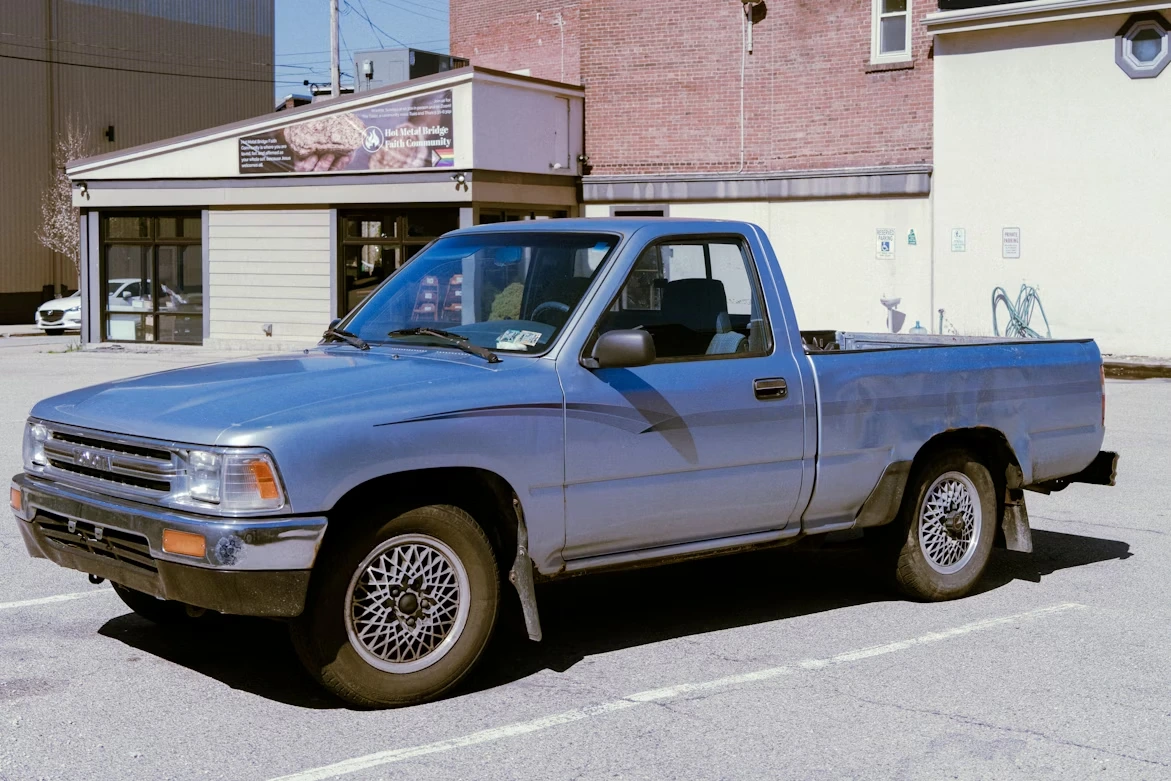 Blue pickup truck parked in a parking lot