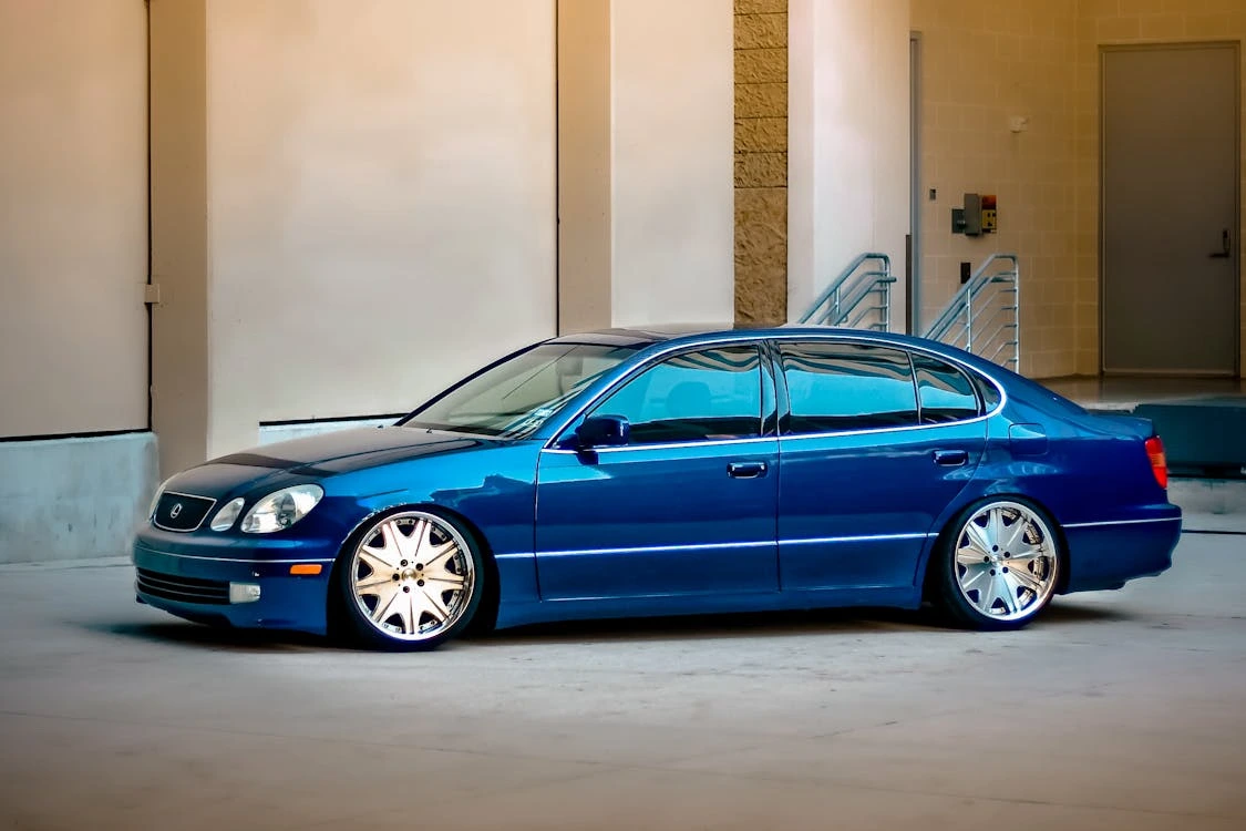 Elegant blue sedan parked outside in a modern urban setting