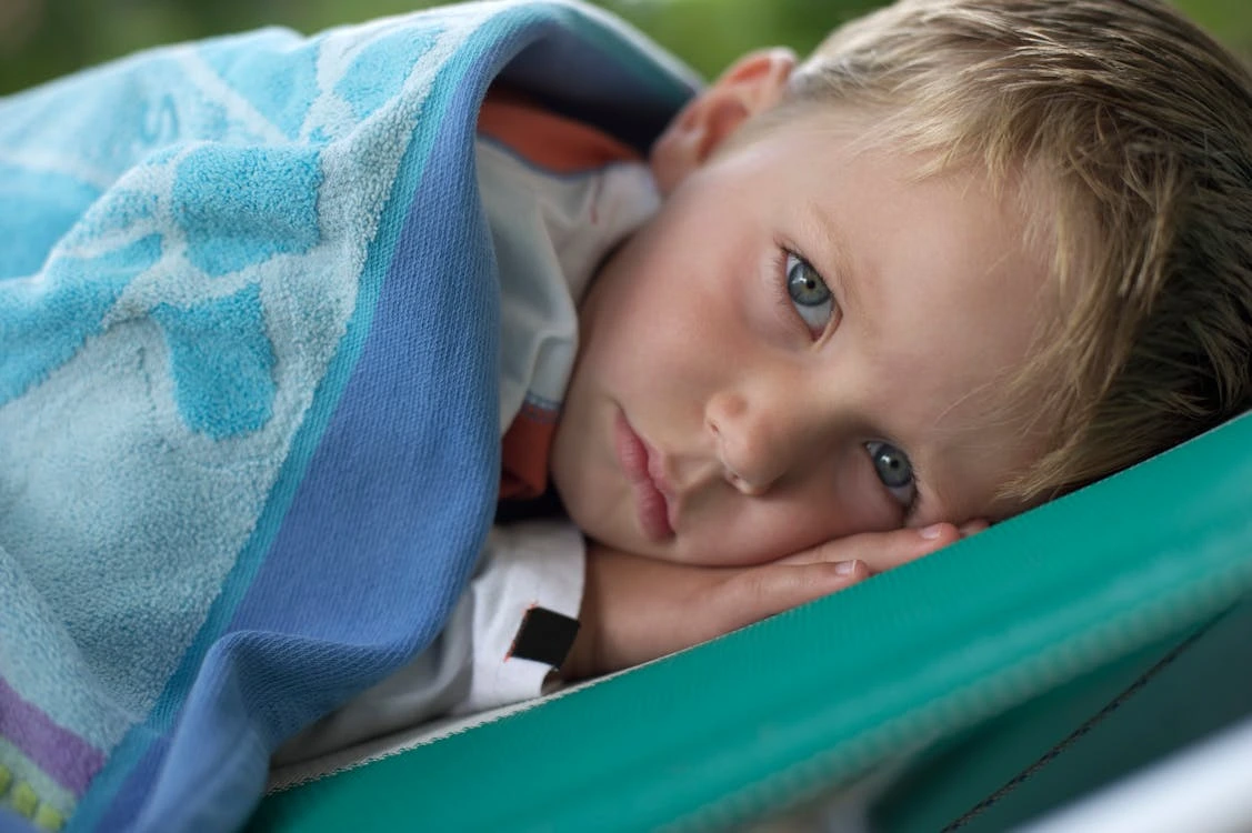Sick boy lying on the bed