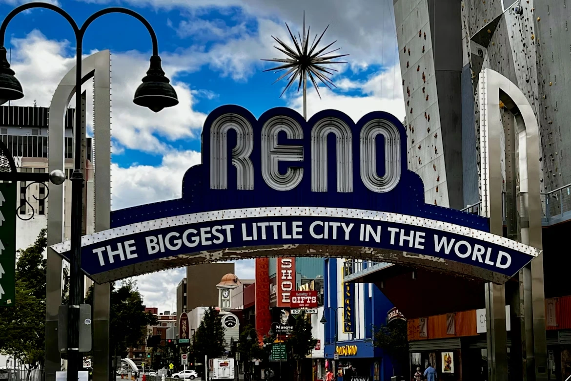 A city street with the “Reno – The Biggest Little City in the World” arch