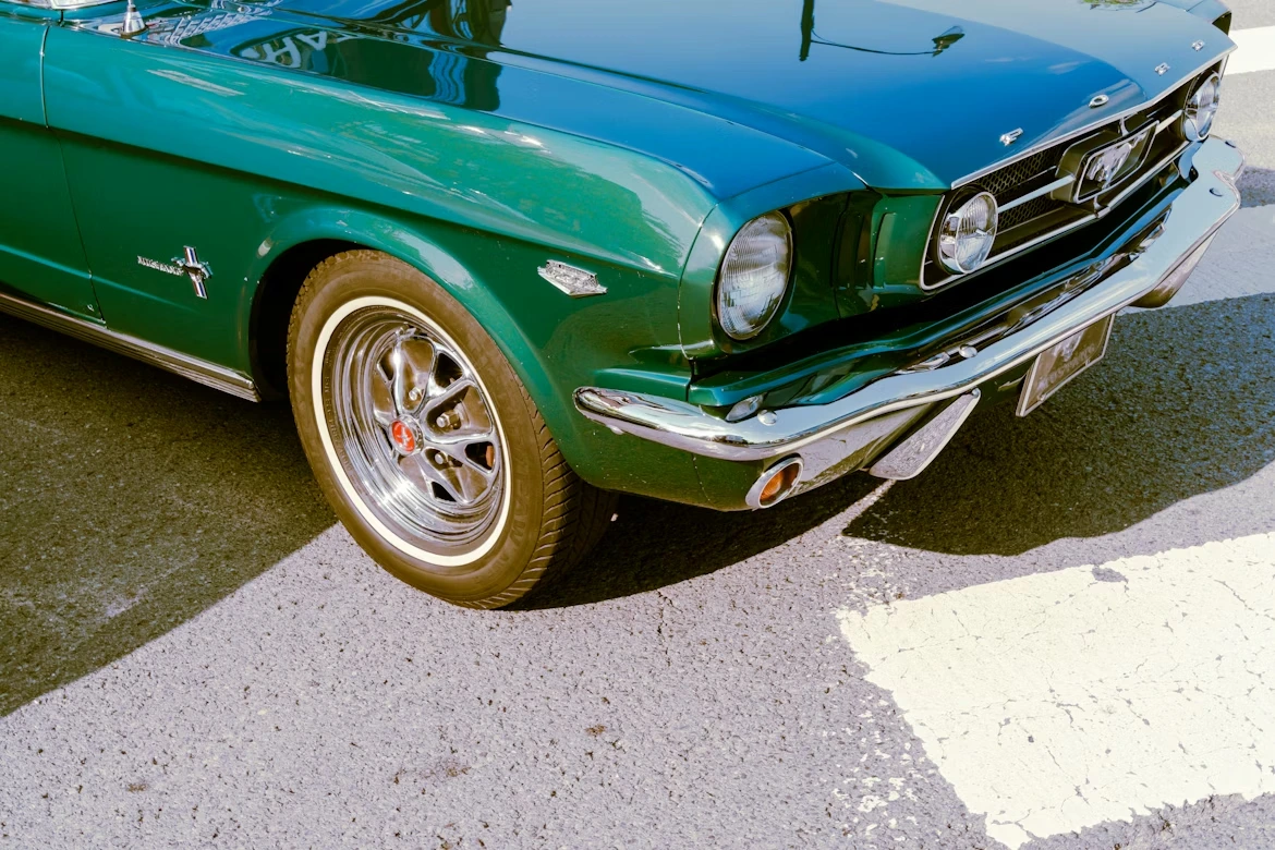 Green vintage car parked on the side of the road