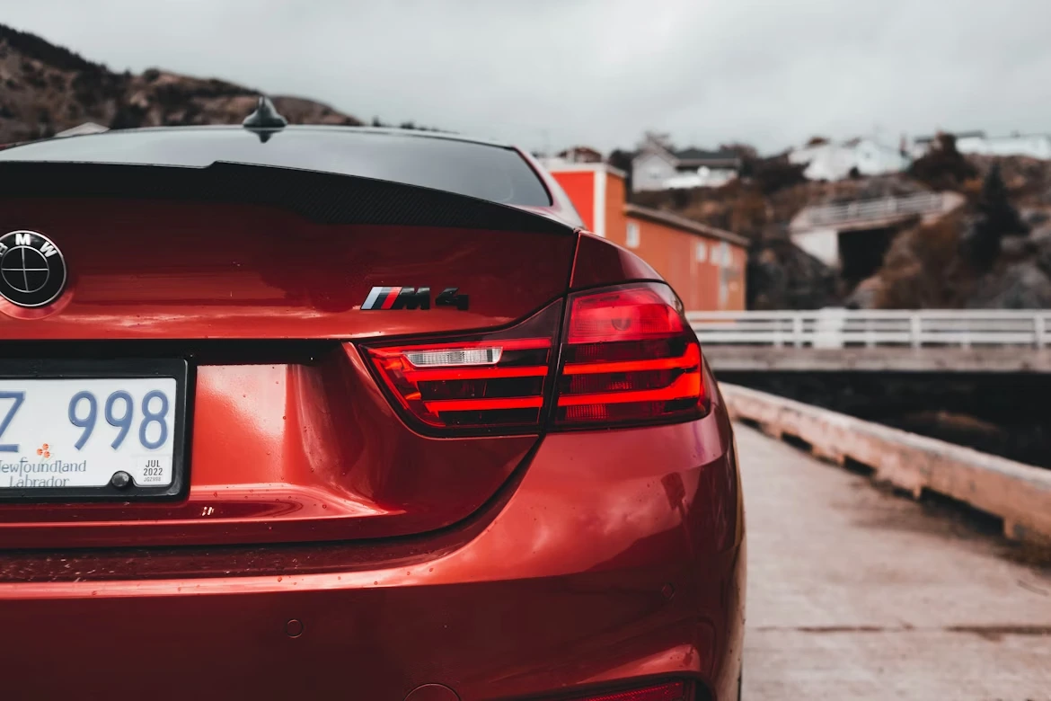 A red car parked on the side of a road