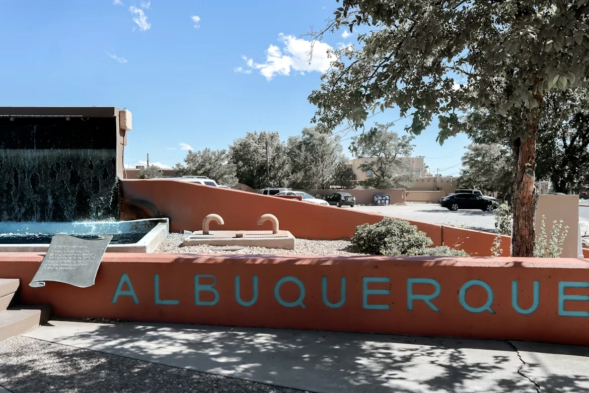 A sign that reads “Albuquerque” with a waterfall in the background in Albuquerque, New Mexico