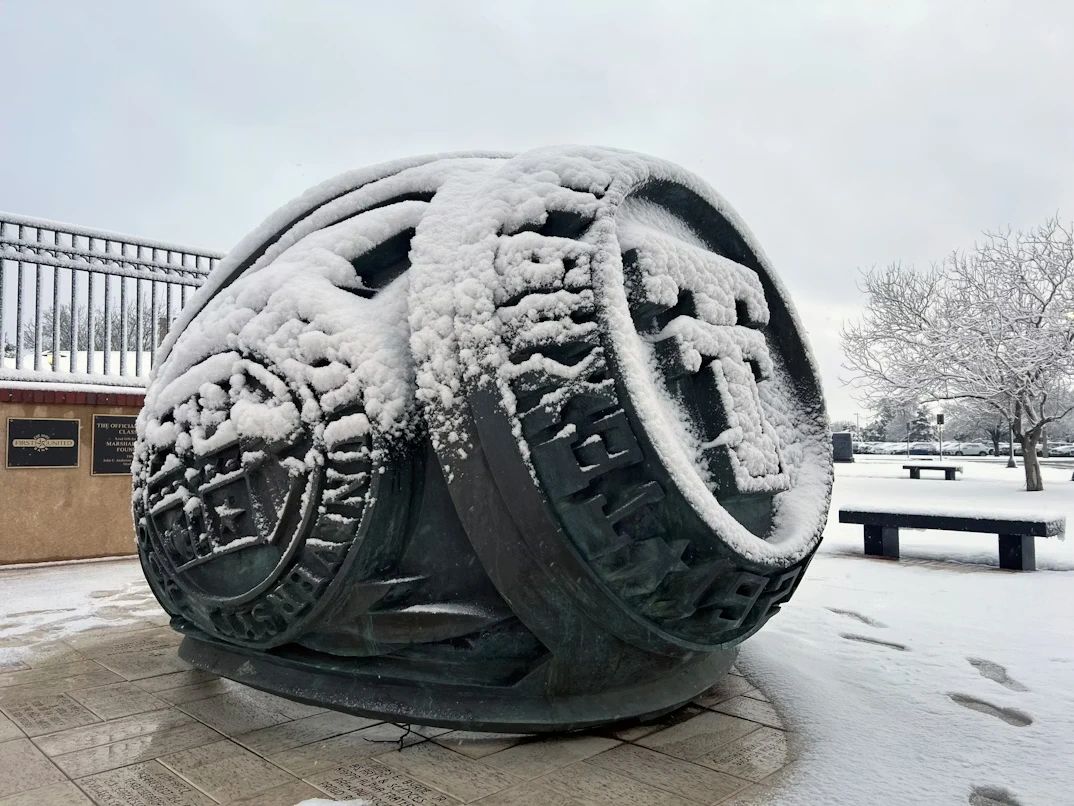 Snow-covered tire sculpture outside a building in Lubbock, Texas