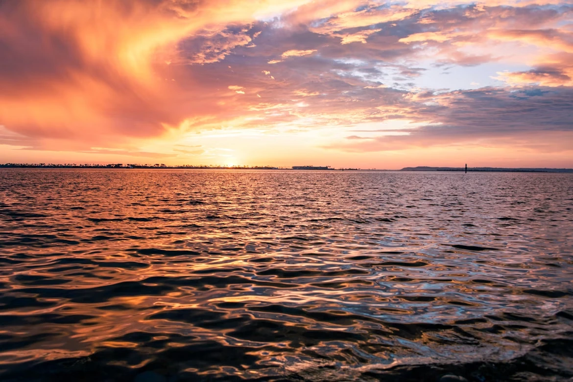 Sunset over the bay with boat in the distance in Chula Vista, California