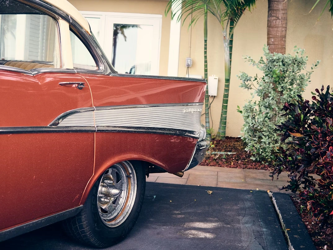 Old red Chevrolet parked in front of a house in Key West, Florida