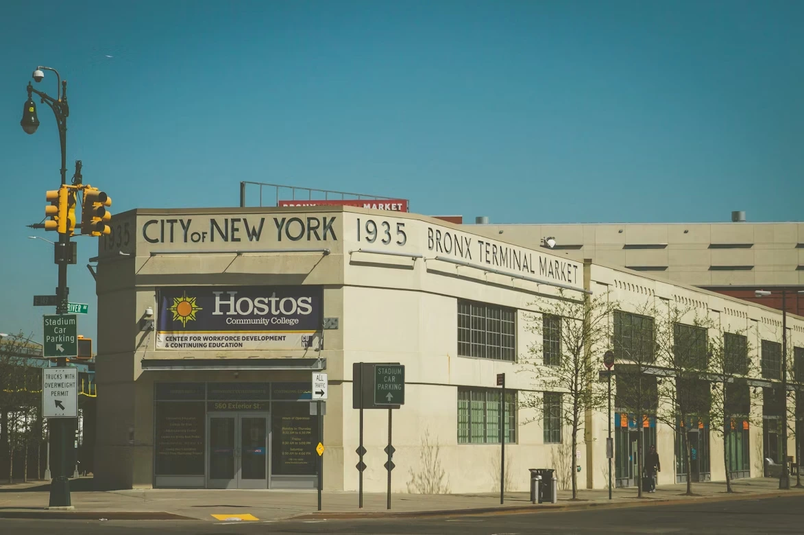 Beige 2-storey building with street scene in the Bronx, New York, United States