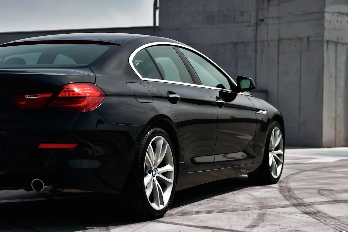 Black sedan parked near a building