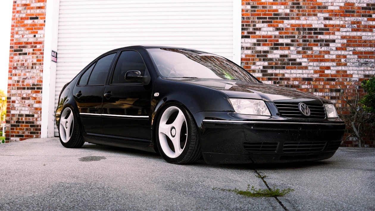 Black tuned Volkswagen Jetta parked on a city street