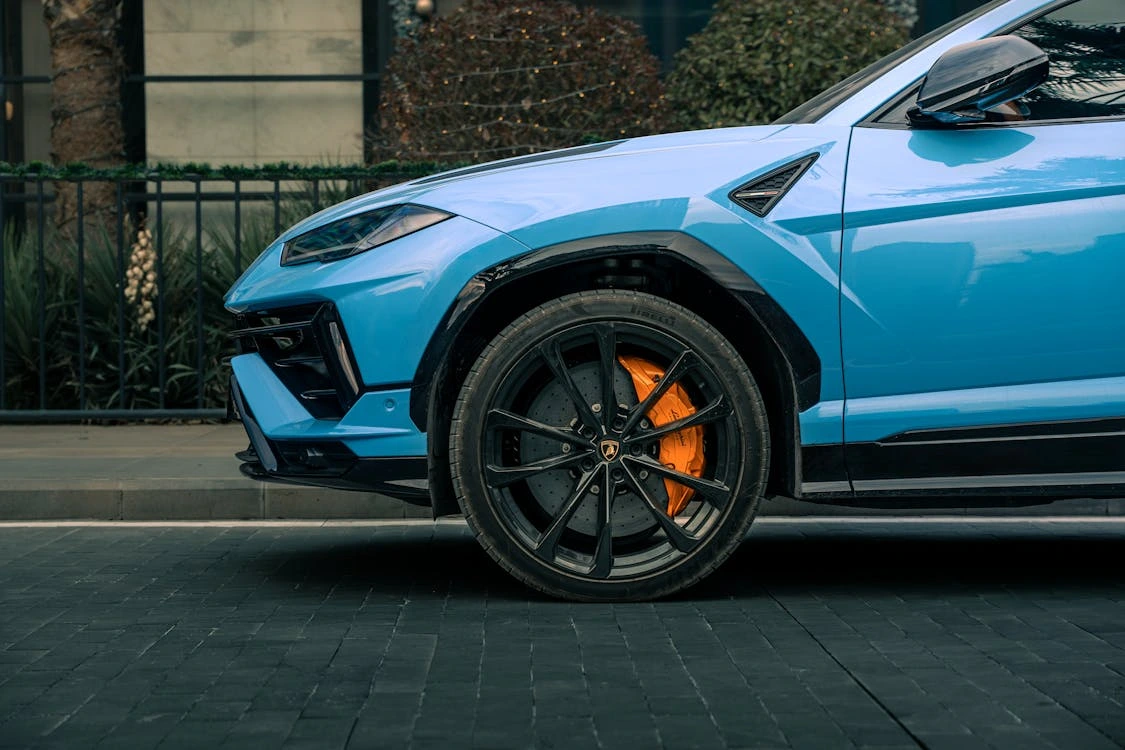 Blue luxury SUV parked on an urban street