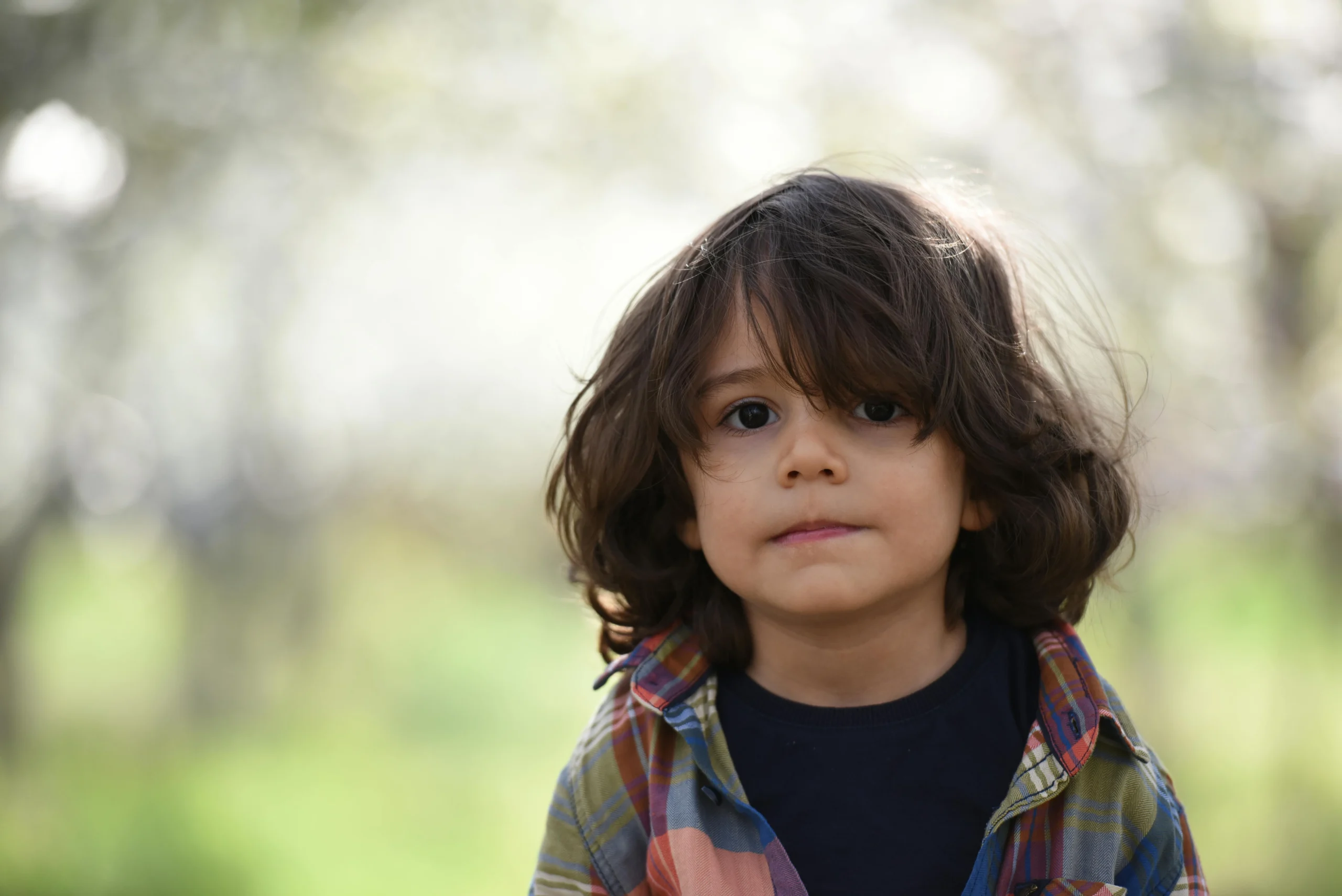 Boy facing the camera in a selective-focus portrait outdoors