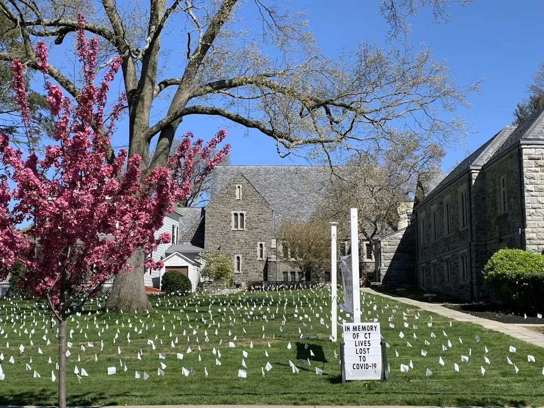 rown and white concrete house near red leaf trees in Old Greenwich, Connecticut