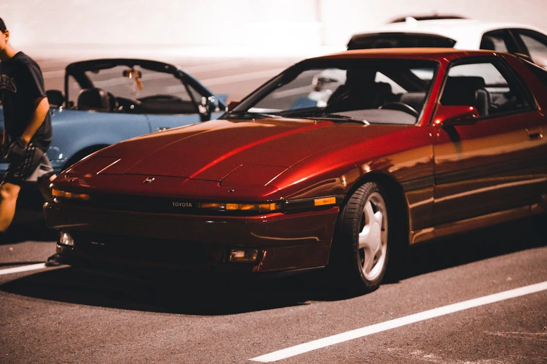 Cars on asphalt in a parking lot at night