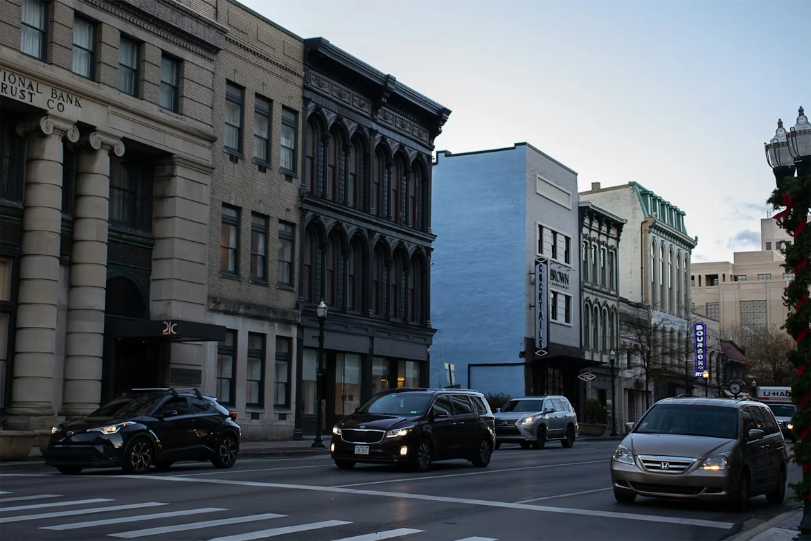 Cars along a street near downtown buildings in Lexington, Kentucky
