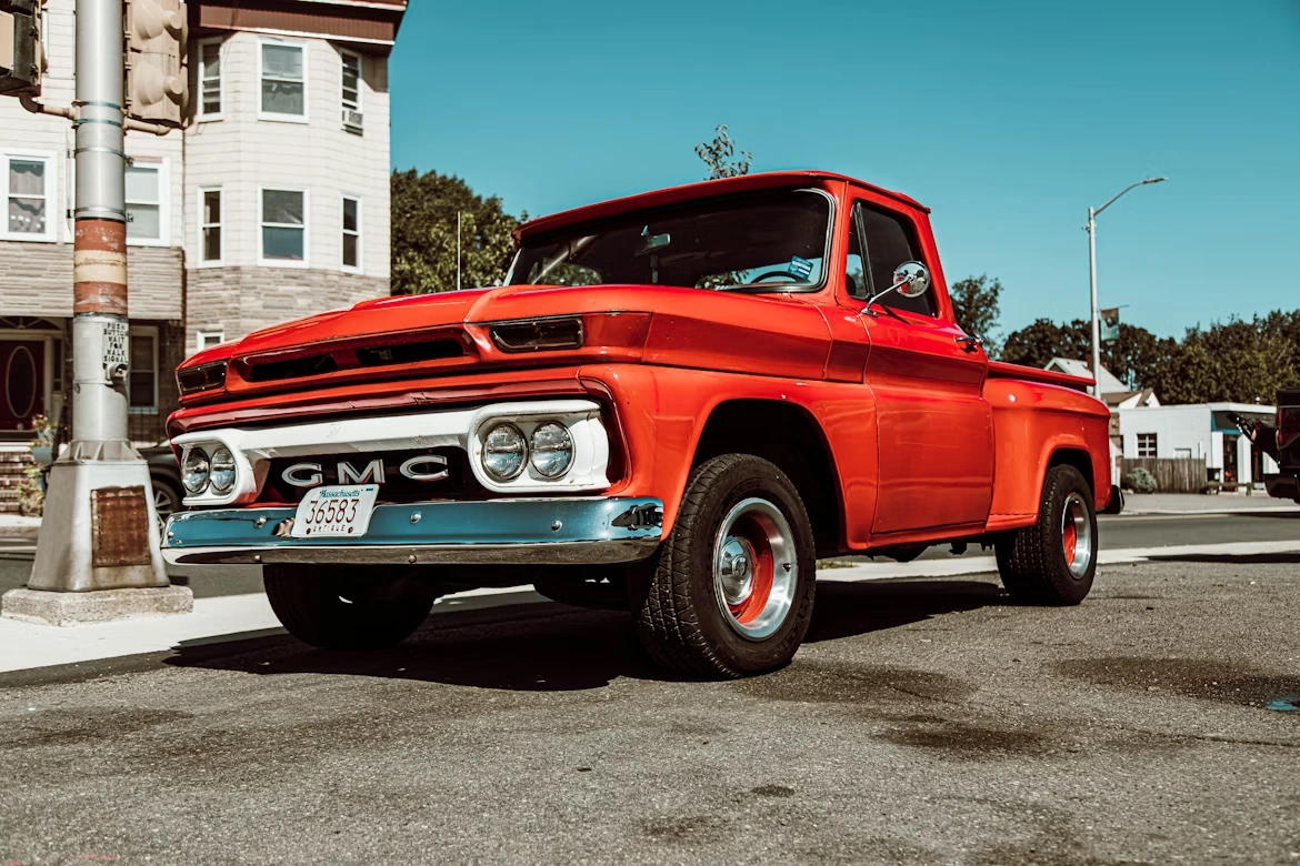 Classic red GMC single cab pickup truck on a road in Winthrop, Massachusetts