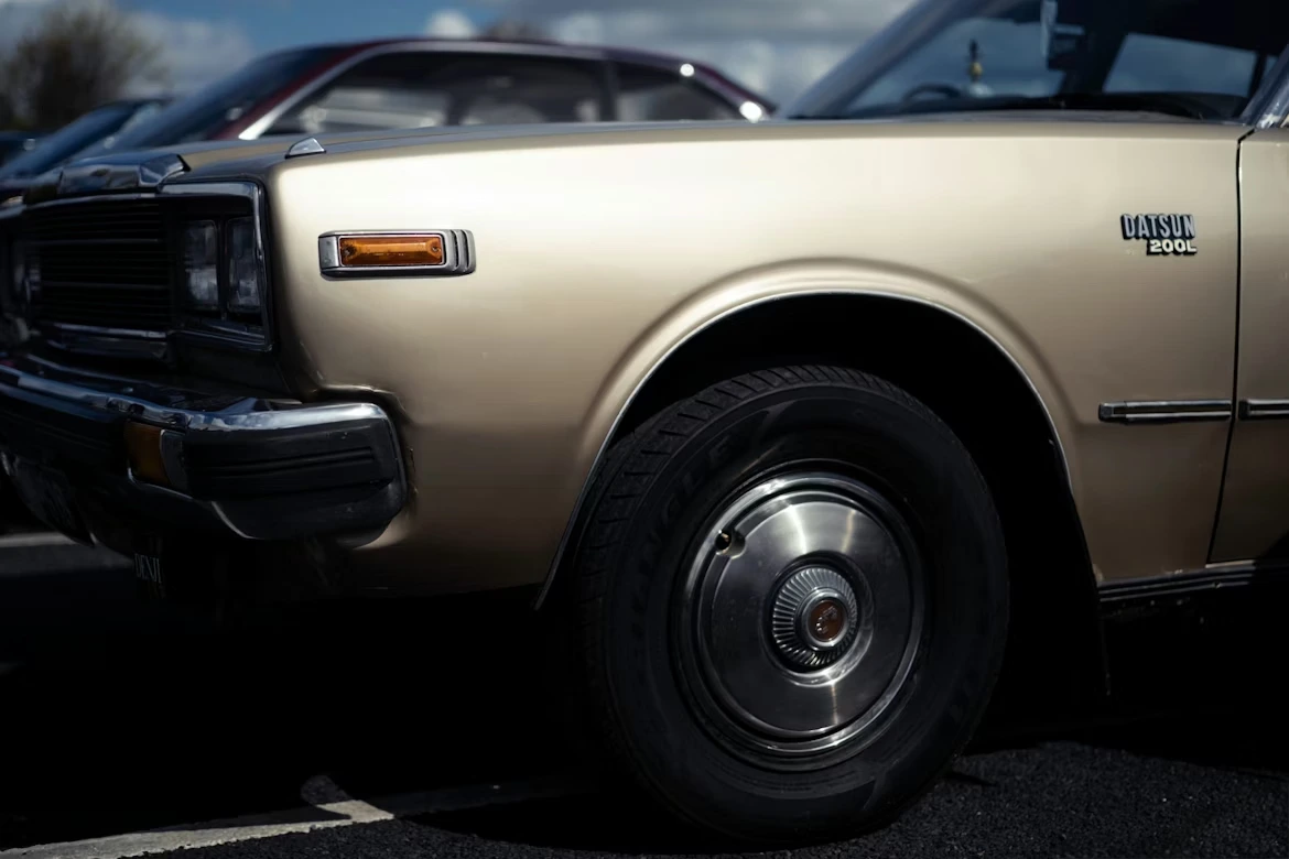 lose-up of a vintage gold car fender and wheel