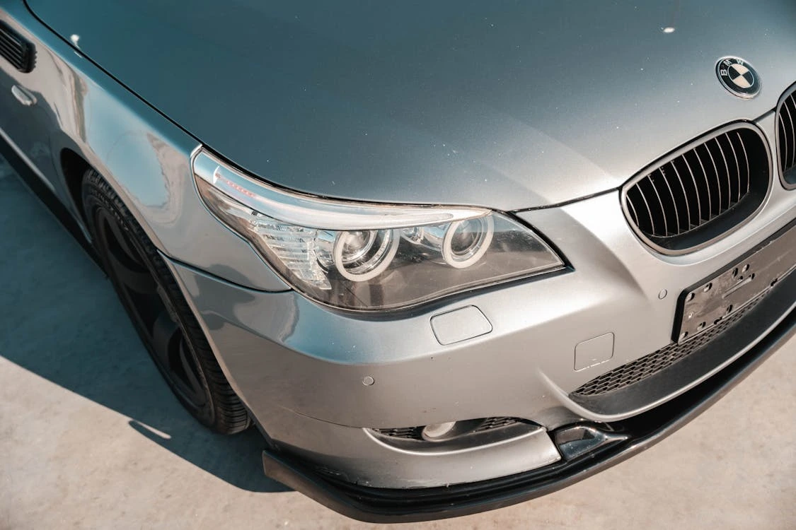 Close-up of the front grille and headlight of a silver BMW M5