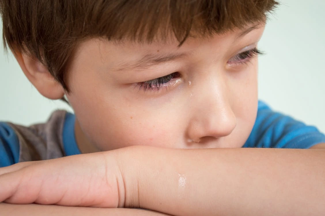 Close-up photo of a boy crying