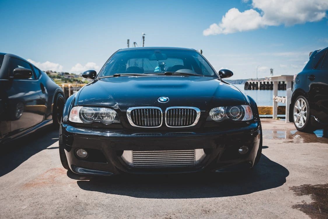 Close-up shot of a black luxury car in a parking lot