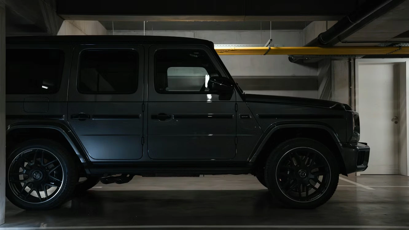 Dark luxury SUV parked in a dimly lit garage