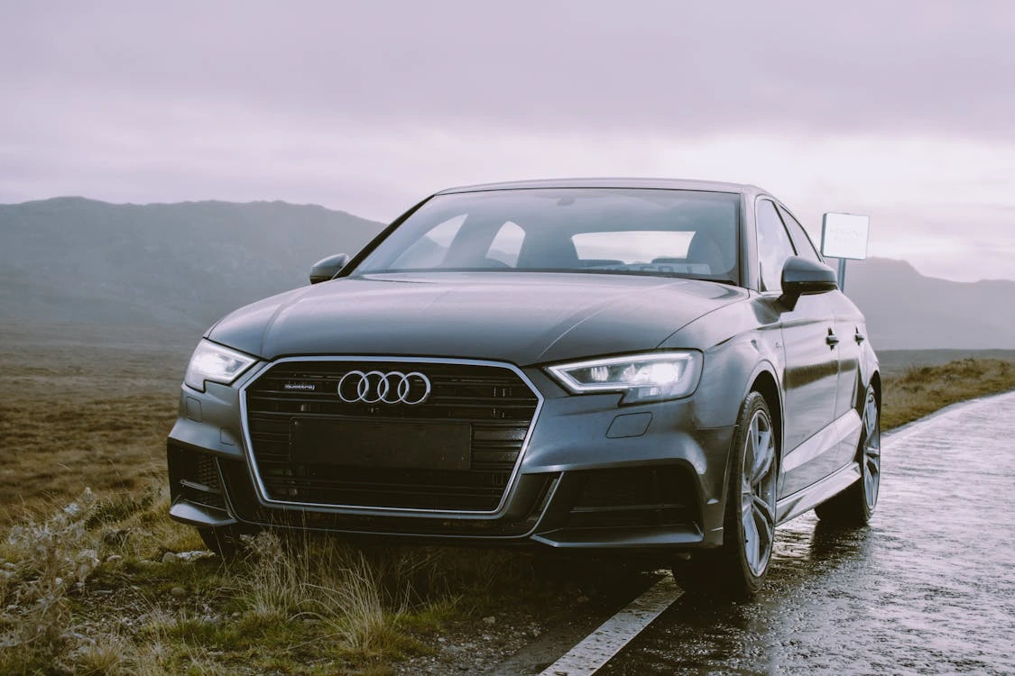 Grey Audi sedan parked beside road
