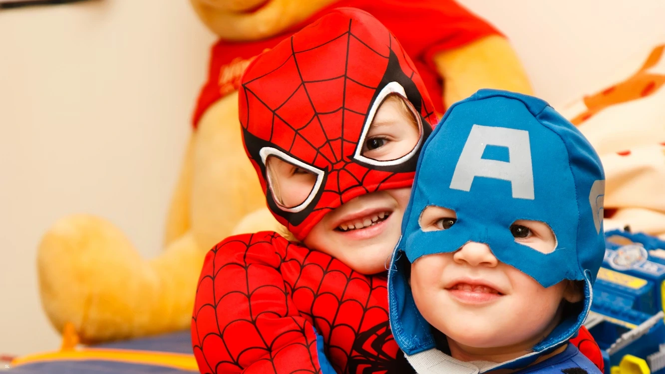 Kids in Spiderman and Captain America costumes