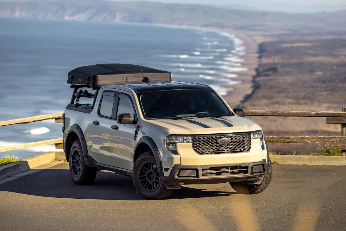 Off-road vehicle overlooking a scenic coastal view with ocean horizon