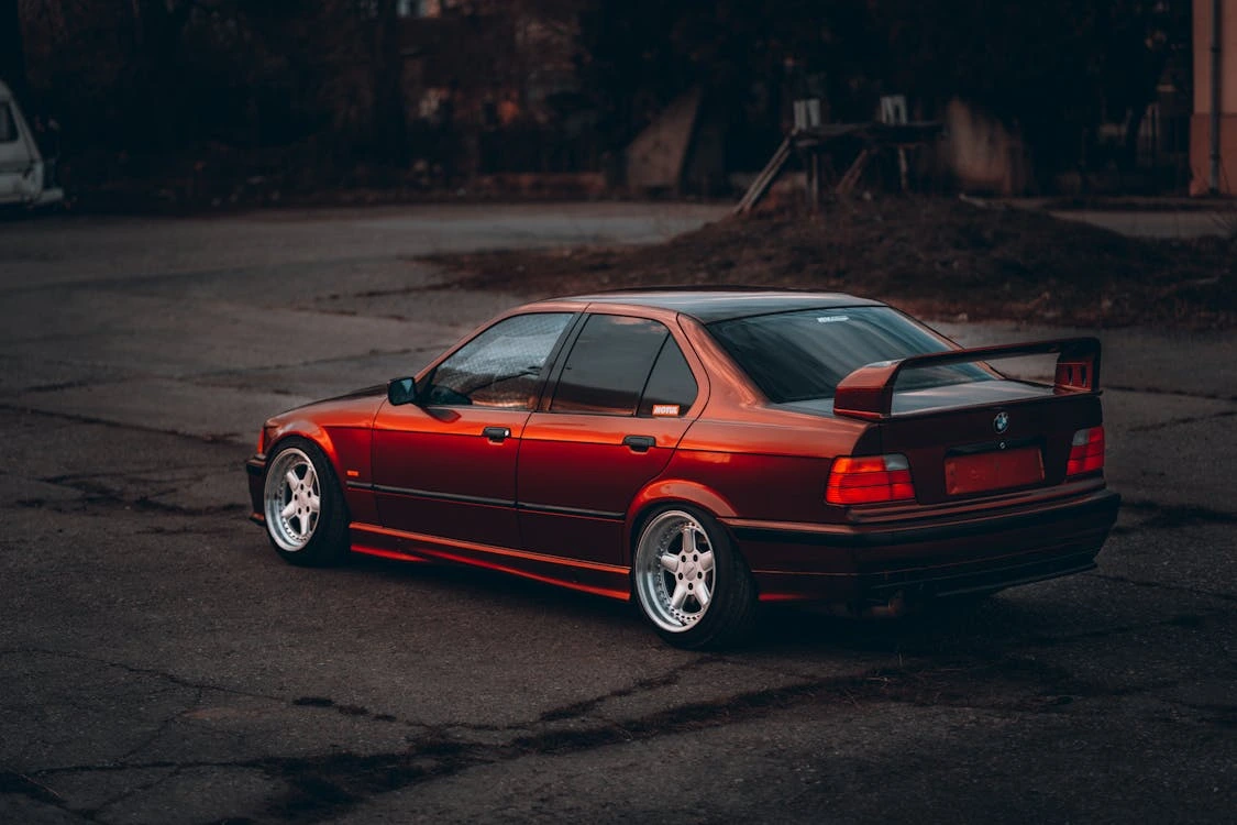 Photo of a red metallic tuning car parked outdoors