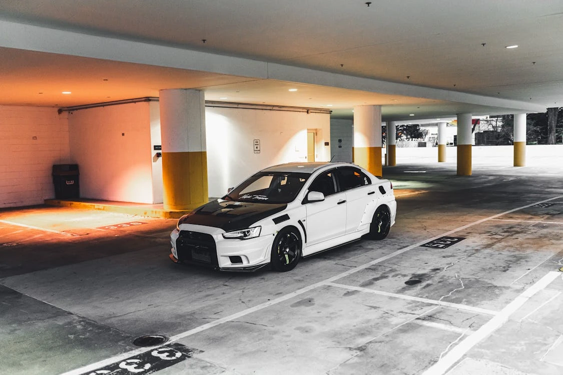 White sedan in a parking lot