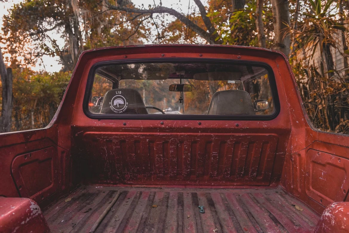 Red car parked on the side of the road in San Juan del Obispo, Guatemala