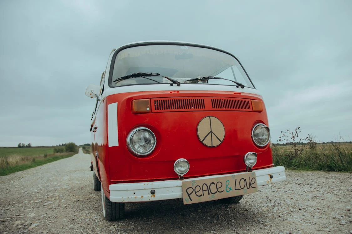 Red hippie mini van on a rural road