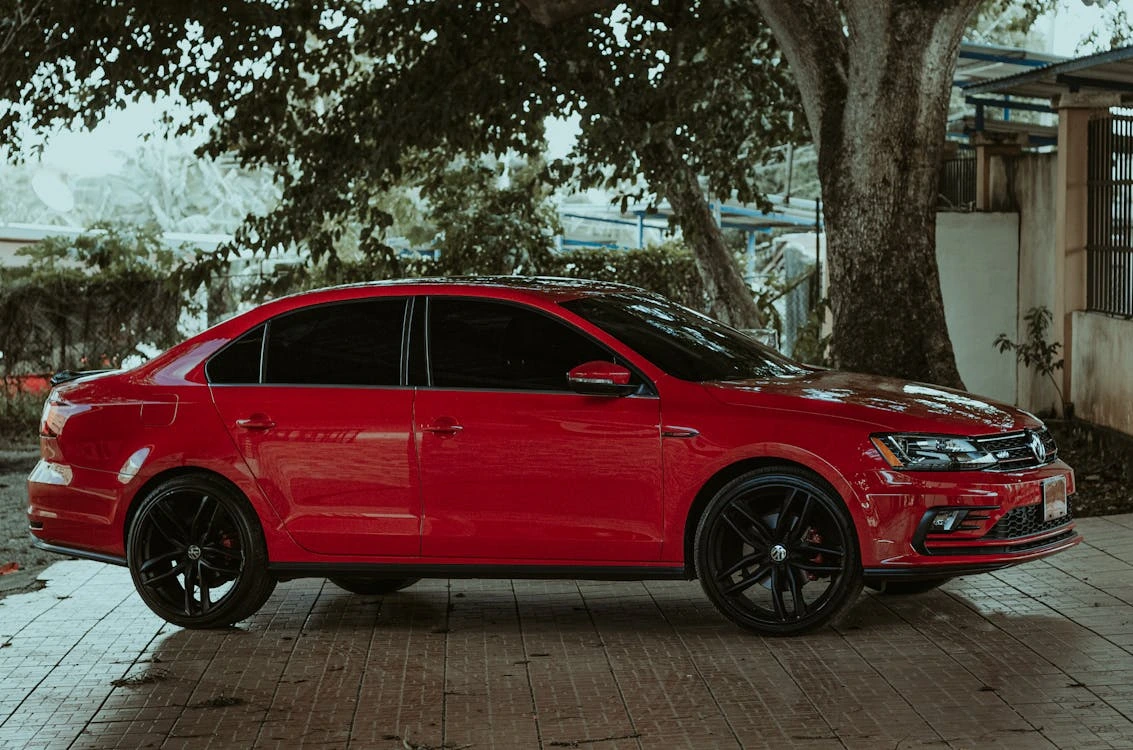 Red sedan car in a car park