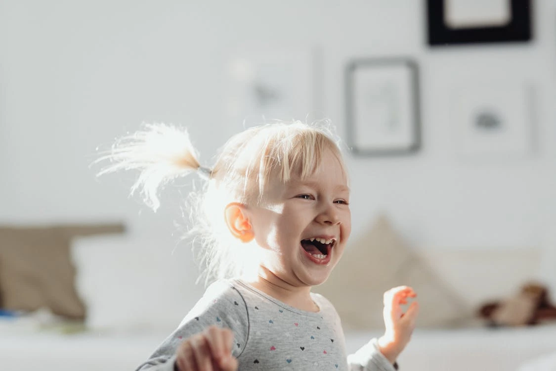 Shallow focus photo of a cute girl laughing