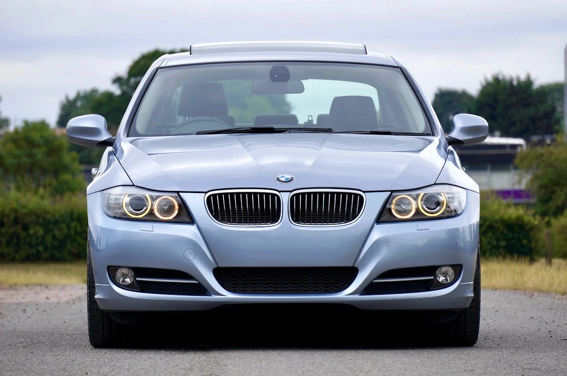 Silver BMW sedan parked on a paved parking area