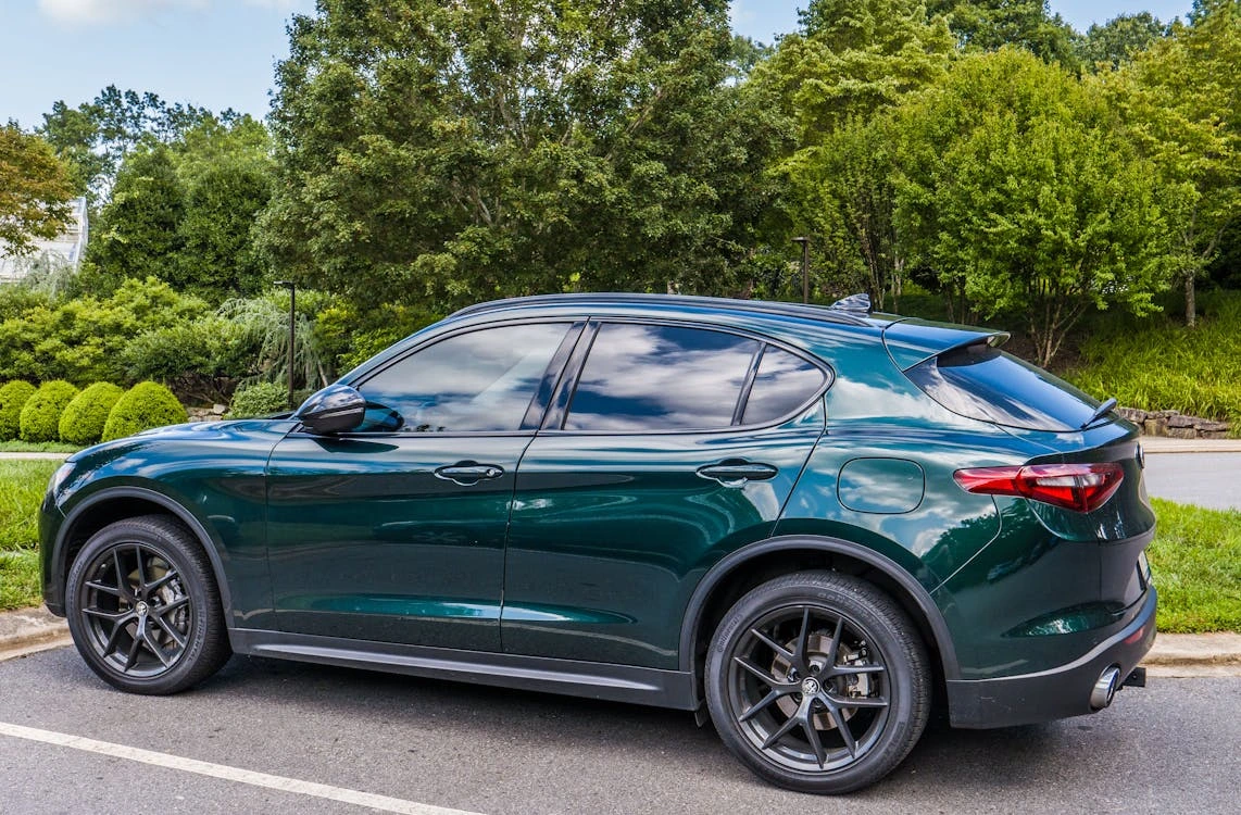 Sleek green SUV parked in a scenic outdoor setting