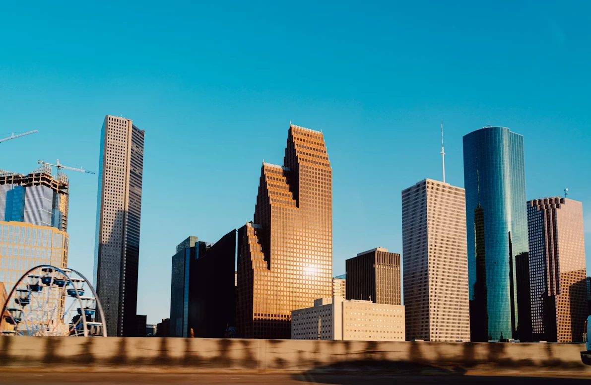 White and blue high-rise building under a clear sky in Houston, Texas
