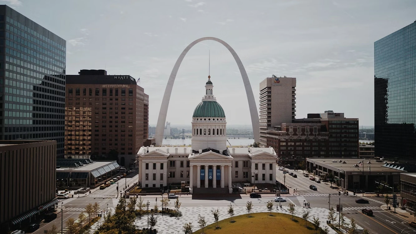 White and green dome cathedral among skyscrapers in St. Louis, Missouri