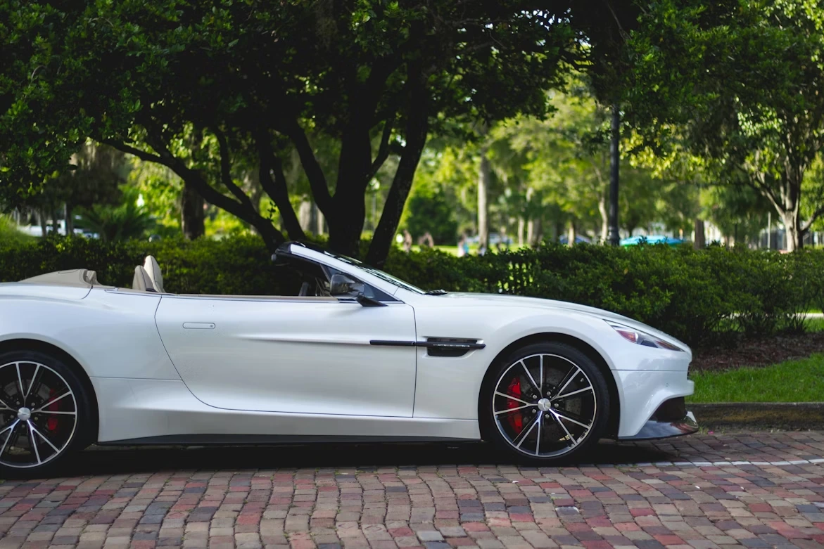 White Aston Martin convertible parked near trees in Winter Park, Florida