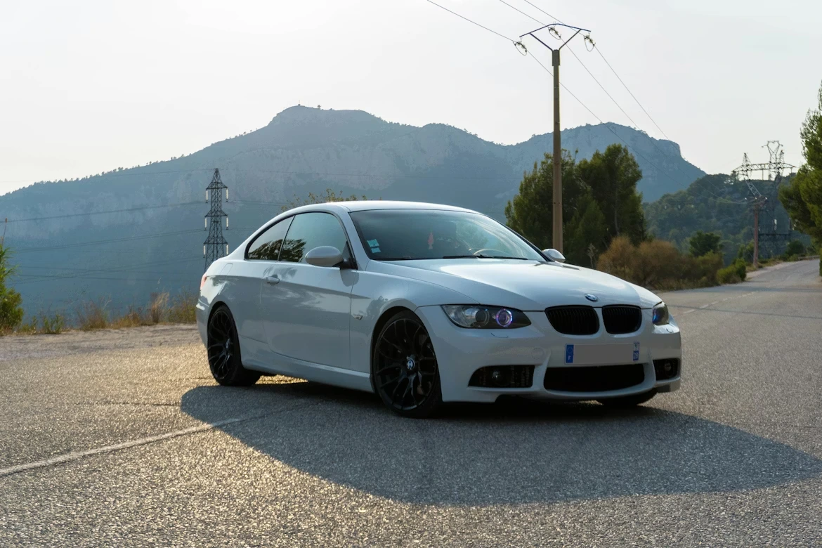 White BMW coupe on a road