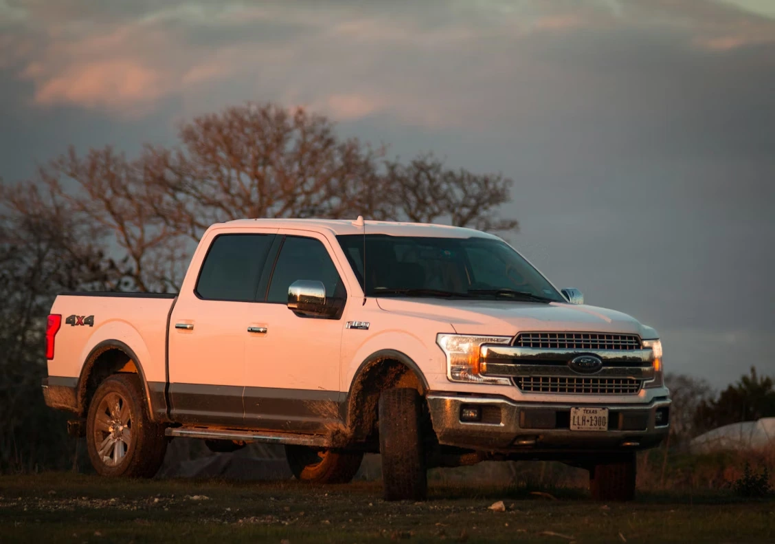 White Chevrolet Crew Cab pickup truck on a brown field during daytime